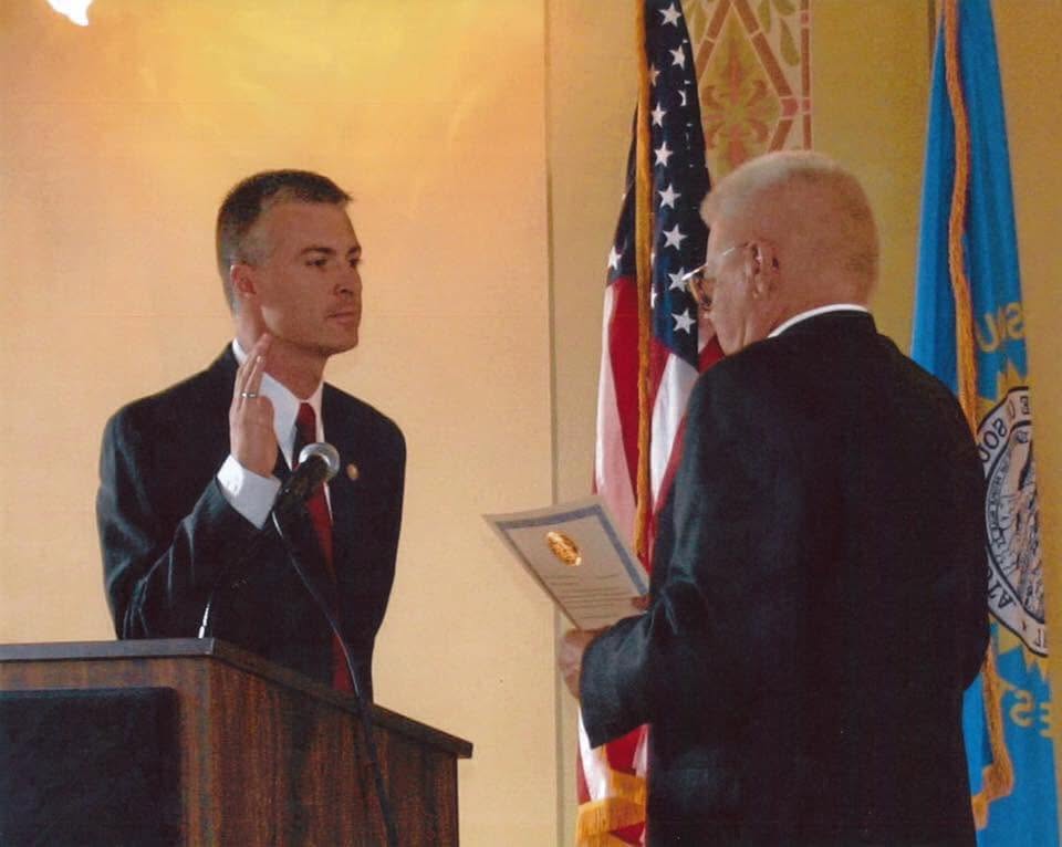 Mike Jackley administers the oath of office to his son Marty